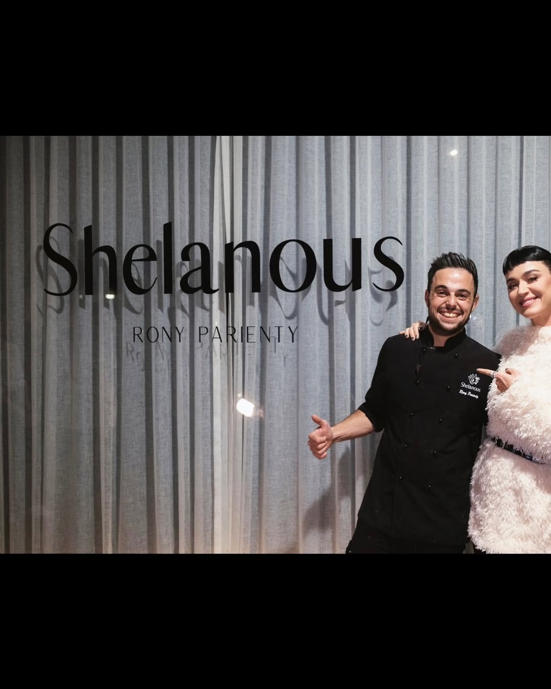 Chef Rony Parienty and Katy Perry in front of the Shelanous sign